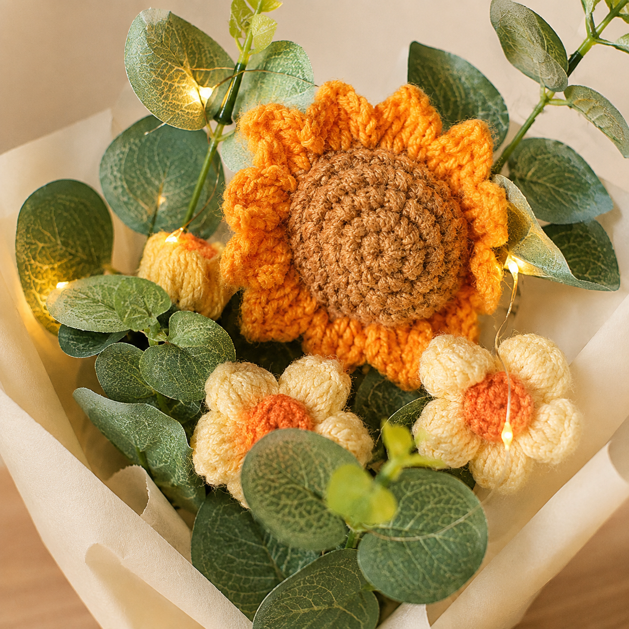 Close-up of crochet sunflower stitches and warm micro lights