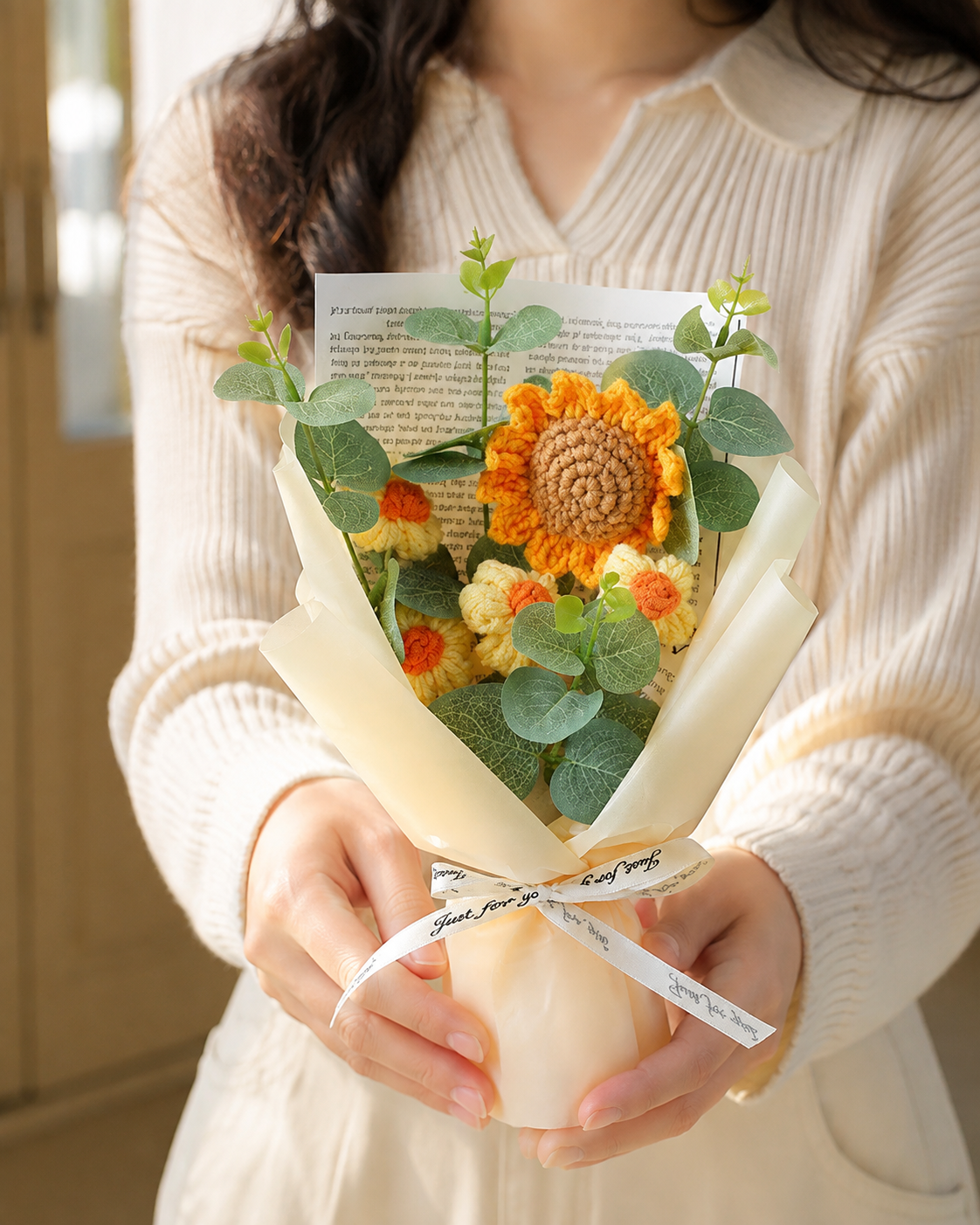 Woman presenting a hand-knitted wool sunflower bouquet
