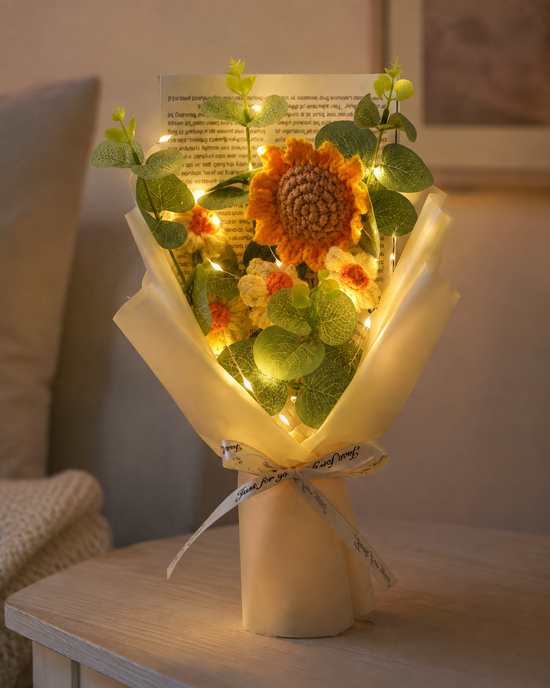Hand-knitted wool sunflower bouquet with warm decorative lights switched on